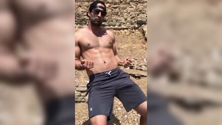 Şortunda kocaman bir şişkinlik olan seksi adam